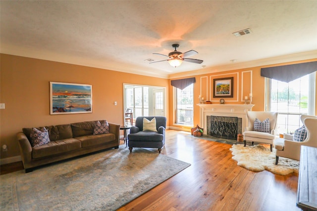 101 N Hall Dr, Sugar Land, TX 77478 - living room with crown molding, ceiling fan, a premium fireplace, wood finished floors, and baseboards