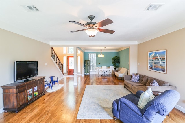 101 N Hall Dr, Sugar Land, TX 77478 - living room with crown molding, stairway, light wood finished floors, ceiling fan, and baseboards
