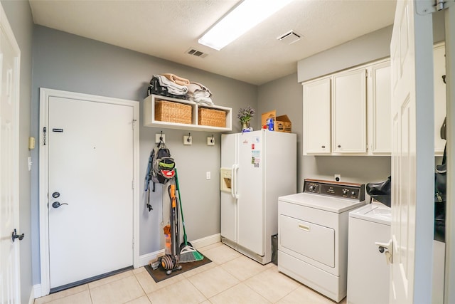 101 N Hall Dr, Sugar Land, TX 77478 - washroom with washing machine and clothes dryer, cabinet space, baseboards, and light tile patterned floors