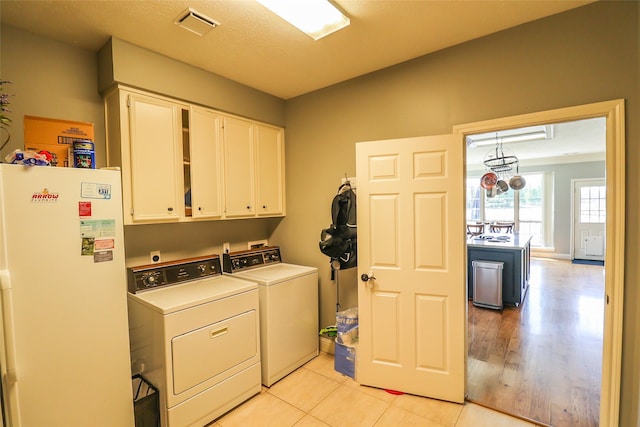 101 N Hall Dr, Sugar Land, TX 77478 - laundry area with cabinet space and separate washer and dryer