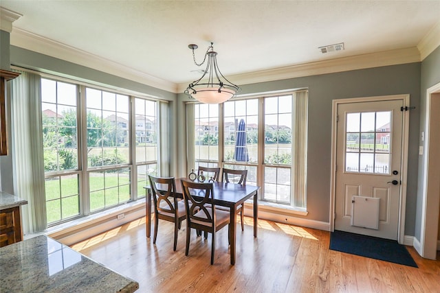 101 N Hall Dr, Sugar Land, TX 77478 - dining area featuring baseboards, plenty of natural light, light wood finished floors, and crown molding