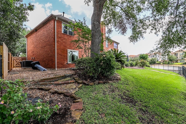 101 N Hall Dr, Sugar Land, TX 77478 - view of property exterior featuring central AC unit and brick siding