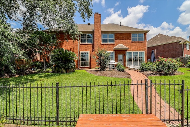 101 N Hall Dr, Sugar Land, TX 77478 - rear view of house with brick siding and a chimney
