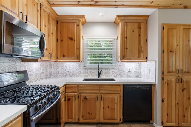 21 Riverbank Dr, The Woodlands, TX 77381 - kitchen with black dishwasher, gas range, stainless steel microwave, a sink, and light countertops
