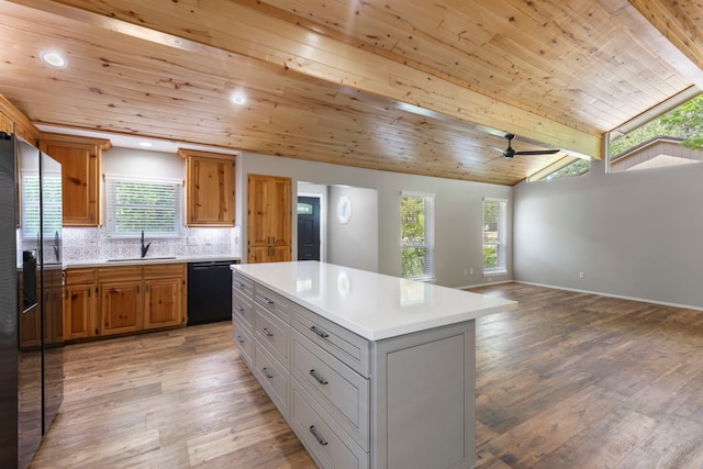 21 Riverbank Dr, The Woodlands, TX 77381 - kitchen with black dishwasher, a sink, refrigerator with ice dispenser, wooden ceiling, and light countertops