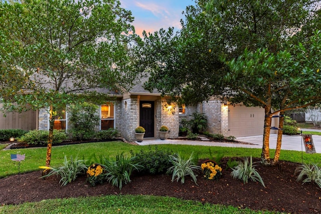 21 Riverbank Dr, The Woodlands, TX 77381 - view of property hidden behind natural elements with an attached garage, concrete driveway, and a front lawn