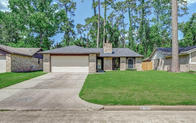 view of front of home with a chimney, a garage, driveway, brick siding, and a front yard