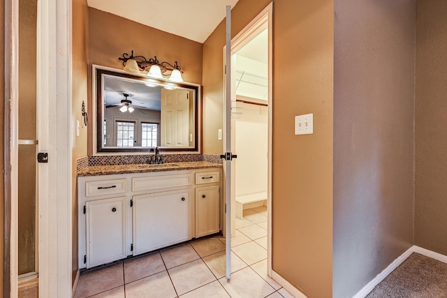bathroom with a ceiling fan, vanity, and tile patterned floors