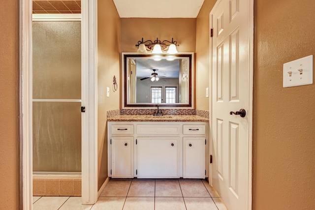 full bathroom featuring tile patterned flooring, a shower stall, a ceiling fan, and vanity