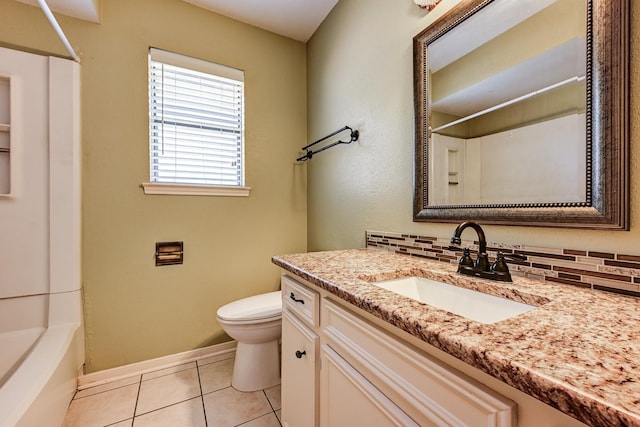 full bath with toilet, tile patterned floors, vanity, baseboards, and shower / bathtub combination