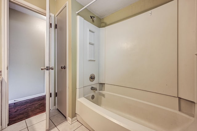 full bath with shower / bathtub combination, tile patterned flooring, and baseboards