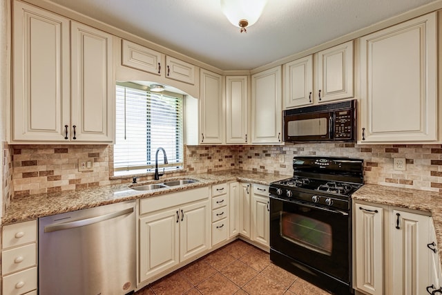 kitchen with black appliances, a sink, light tile patterned floors, and cream cabinets