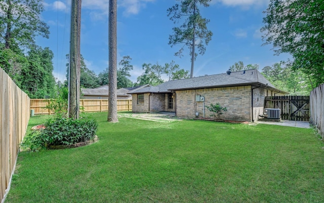 back of property with central AC unit and brick siding