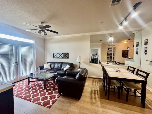 1711 Old Spanish Trl Unit 323, Houston, TX 77054 - living room with ornamental molding, a ceiling fan, wood finished floors, track lighting, and baseboards