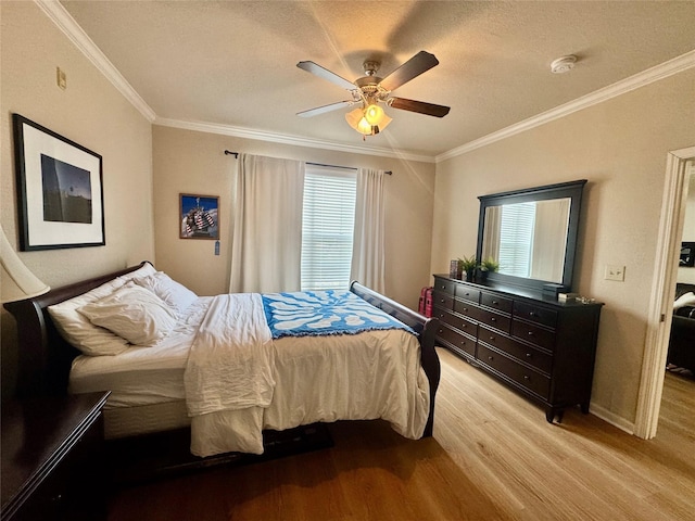 1711 Old Spanish Trl Unit 323, Houston, TX 77054 - bedroom with wood finished floors, multiple windows, ornamental molding, a textured ceiling, and a ceiling fan