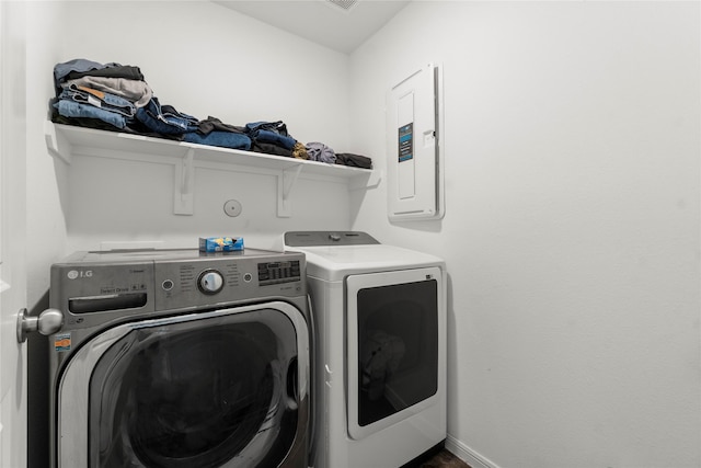 247 Pine Cavern Dr, Willis, TX 77378 - laundry area featuring washing machine and dryer, electric panel, and baseboards