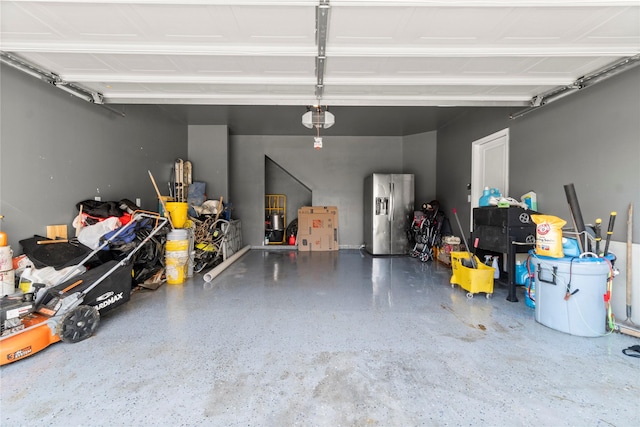 247 Pine Cavern Dr, Willis, TX 77378 - garage with stainless steel fridge with ice dispenser and a garage door opener
