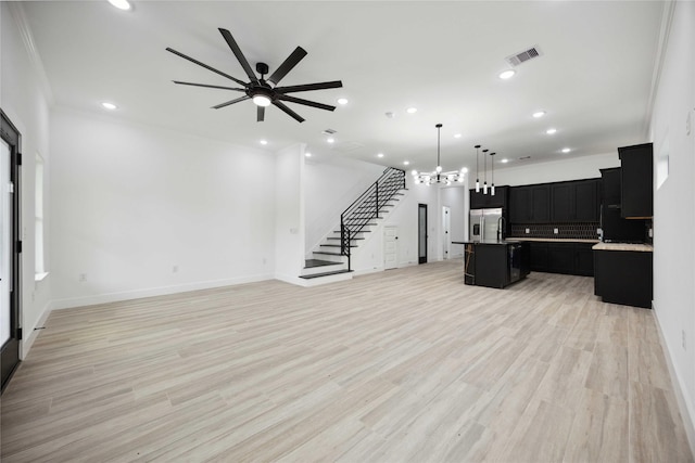 unfurnished living room with stairs, recessed lighting, a ceiling fan, baseboards, and light wood-style floors