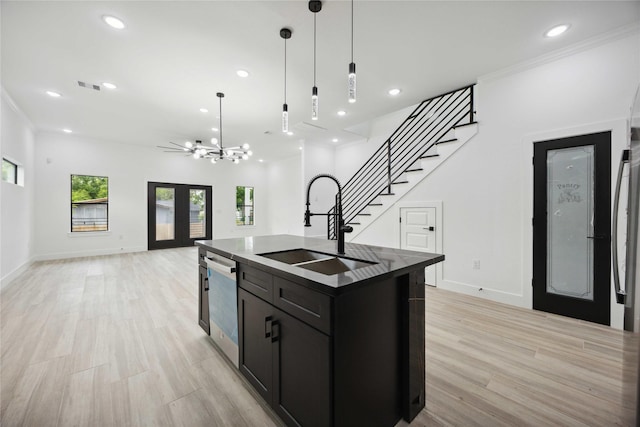 kitchen featuring a sink, stainless steel dishwasher, open floor plan, recessed lighting, and a kitchen island with sink