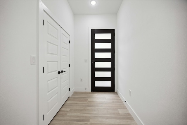 entryway featuring light wood-type flooring, recessed lighting, and baseboards