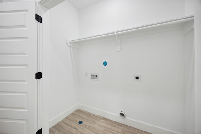 laundry room featuring electric dryer hookup, washer hookup, light wood-style flooring, and baseboards