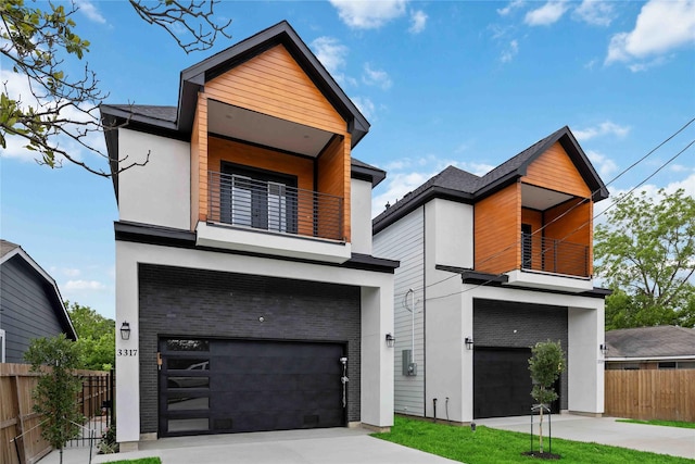 modern home featuring a balcony, a garage, fence, stucco siding, and driveway