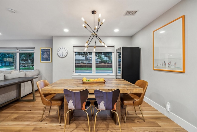 8518 Westview Dr, Houston, TX 77055 - dining area featuring a chandelier, light wood finished floors, recessed lighting, and baseboards