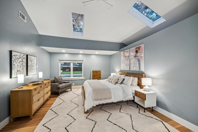 8518 Westview Dr, Houston, TX 77055 - bedroom featuring a skylight, light wood-style floors, baseboards, and high vaulted ceiling