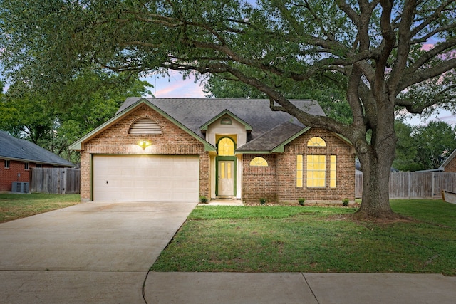 1408 Quail Holw, Sealy, TX 77474 - view of front of house featuring brick siding, concrete driveway, an attached garage, central AC, and roof with shingles