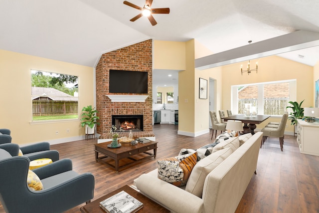 1408 Quail Holw, Sealy, TX 77474 - living area featuring lofted ceiling, a chandelier, ceiling fan, wood finished floors, and healthy amount of natural light