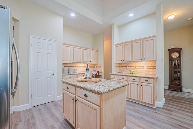19123 Dee Woods Dr, Humble, TX 77346 - kitchen featuring freestanding refrigerator, light brown cabinets, light wood-style floors, backsplash, and recessed lighting