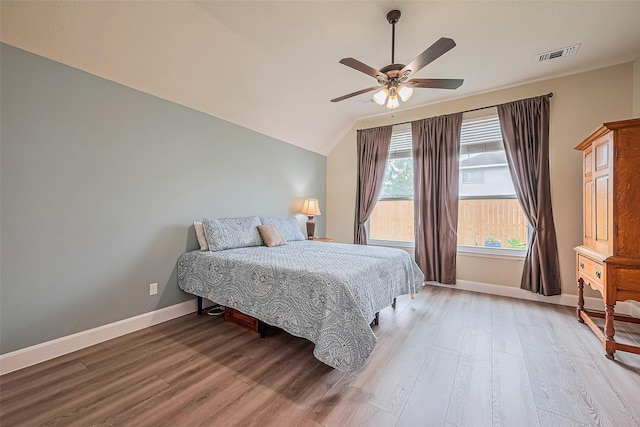 19123 Dee Woods Dr, Humble, TX 77346 - bedroom with wood finished floors, vaulted ceiling, baseboards, and ceiling fan