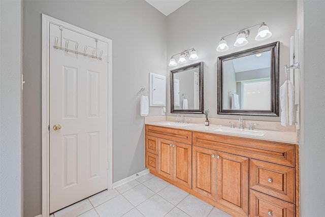 19123 Dee Woods Dr, Humble, TX 77346 - bathroom with tile patterned floors, double vanity, and baseboards