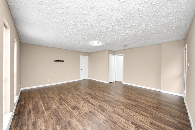 2257 County Road 206, Alvin, TX 77511 - unfurnished room with dark wood-style floors, a textured ceiling, and baseboards