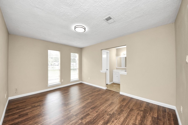 2257 County Road 206, Alvin, TX 77511 - empty room with dark wood-style flooring, baseboards, and a textured ceiling