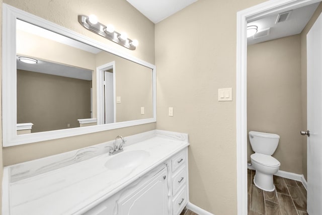 2257 County Road 206, Alvin, TX 77511 - bathroom with toilet, wood finish floors, baseboards, and vanity