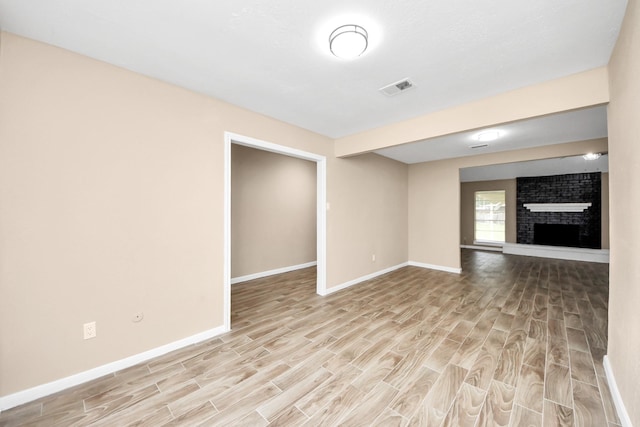 2257 County Road 206, Alvin, TX 77511 - unfurnished living room featuring wood finished floors, baseboards, and a fireplace