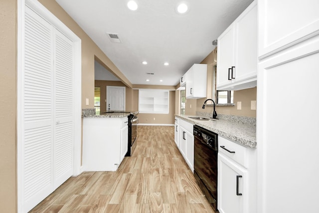 2257 County Road 206, Alvin, TX 77511 - kitchen with dishwasher, a sink, light wood finished floors, stainless steel electric stove, and white cabinetry