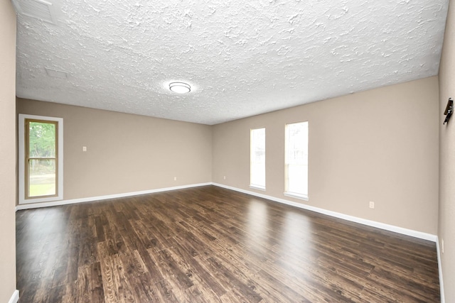 2257 County Road 206, Alvin, TX 77511 - empty room featuring dark wood-style flooring, baseboards, and a textured ceiling