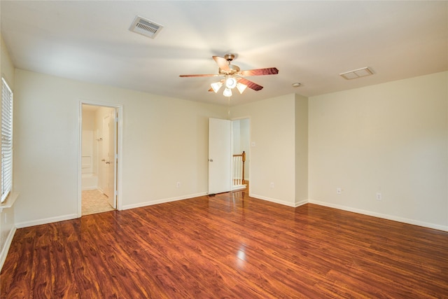 unfurnished room with wood finished floors, ceiling fan, and baseboards