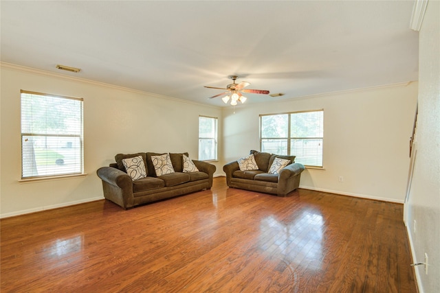 living room featuring crown molding, ceiling fan, wood finished floors, and baseboards