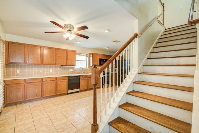 kitchen featuring black appliances, a ceiling fan, brown cabinetry, decorative backsplash, and light countertops