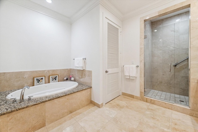 bathroom featuring a stall shower, a garden tub, ornamental molding, and baseboards