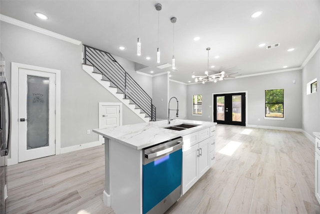 kitchen featuring dishwasher, a sink, crown molding, open floor plan, and recessed lighting