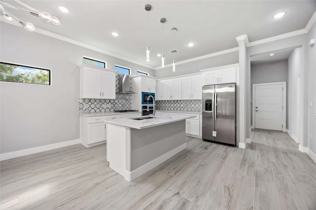 kitchen featuring stainless steel refrigerator with ice dispenser, wall chimney exhaust hood, ornamental molding, tasteful backsplash, and white cabinets