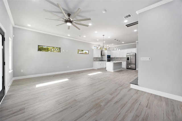 unfurnished living room featuring recessed lighting, a ceiling fan, ornamental molding, a chandelier, and baseboards