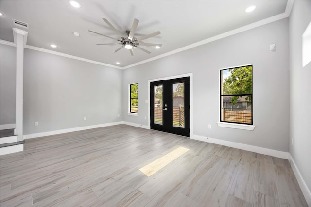 spare room featuring a ceiling fan, recessed lighting, light wood-style flooring, crown molding, and baseboards