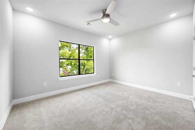 carpeted spare room with recessed lighting, a ceiling fan, and baseboards