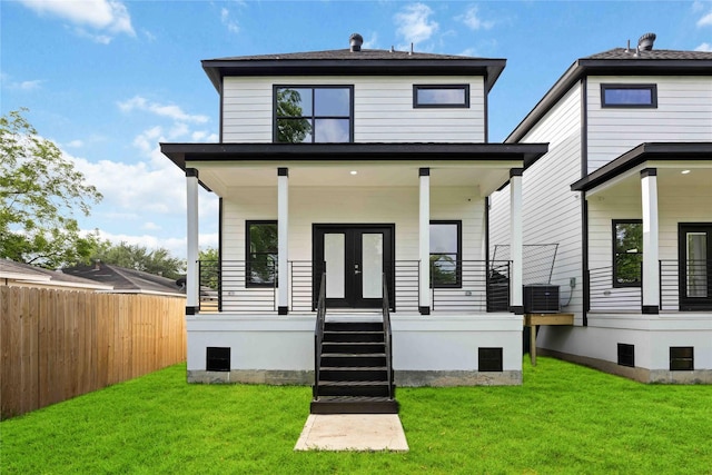 back of house with a porch and central AC