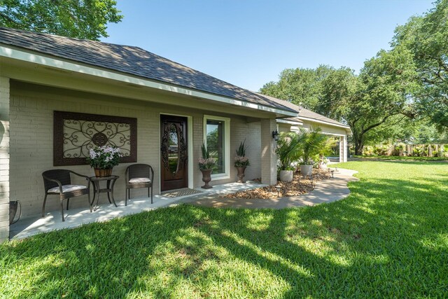 104 Smith Ln, League City, TX 77573 - rear view of house featuring brick siding and a lawn